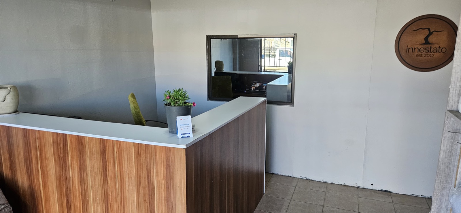 Innestato Auctions reception desk with the est. 2017 branding